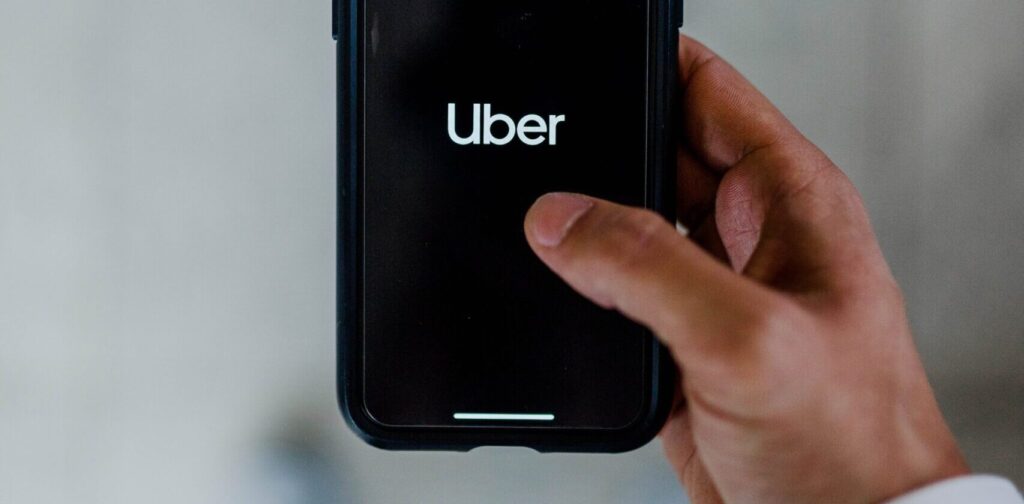 person holding phone on uber app