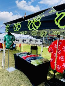 Customers browsing Flower Club clothing at a pop-up