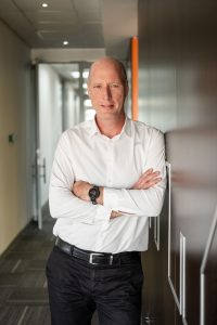 Rob Kelso, CEO of SA Home Loans, standing in an office wearing a white shirt